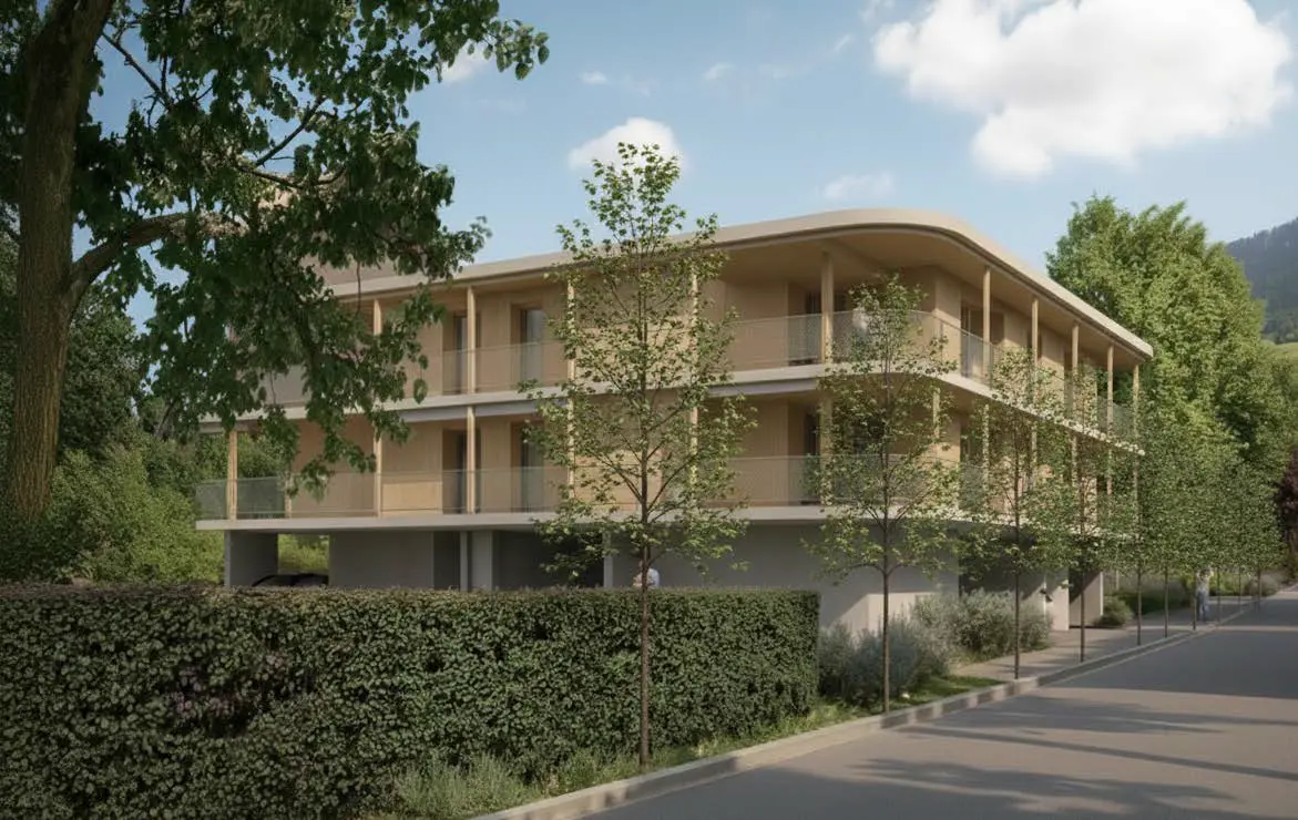Westansicht Rheinhaus Triesen mit gedeckten Loggien und heller Fassade